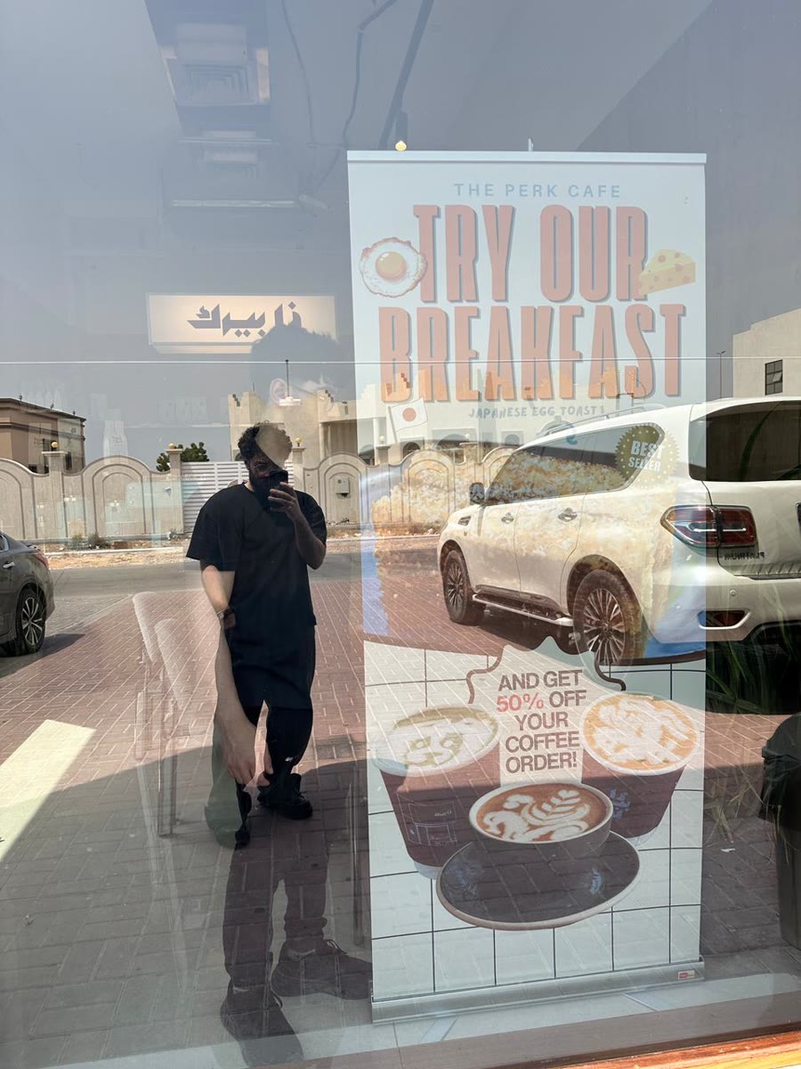 The Perk Cafe breakfast roll-up banner standing in the cafe window